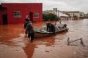 People evacuate a flooded area after heavy rain in Sao Sebastiao do Cai, Brazil (AP Photo/Carlos Macedo)
