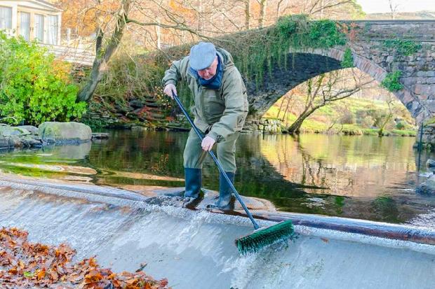 The late Griff Morris volunteers to clean the screens on the hydroelectric plant in Bethesda, a community owned energy enterprise in Gwynedd.