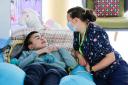 Registered nurse Emma cares for Marshall at Ty Hafan