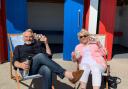Larry Lamb and Alison Steadman on deck chairs outside the iconic Barry Island beach huts (Picture: Barrybados/Facebook)