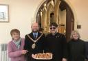 Cllr Ian Johnson, mayor of Barry, with Father Dan Barnes-Davies (centre), before giving out hot cross buns to parishioners at St Mary’s Church on Good Friday