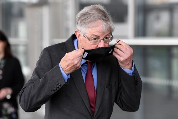 Barry And District News: Mark Drakeford putting on a face covering heading into the Senedd. Picture: Huw Evans Picture Agency