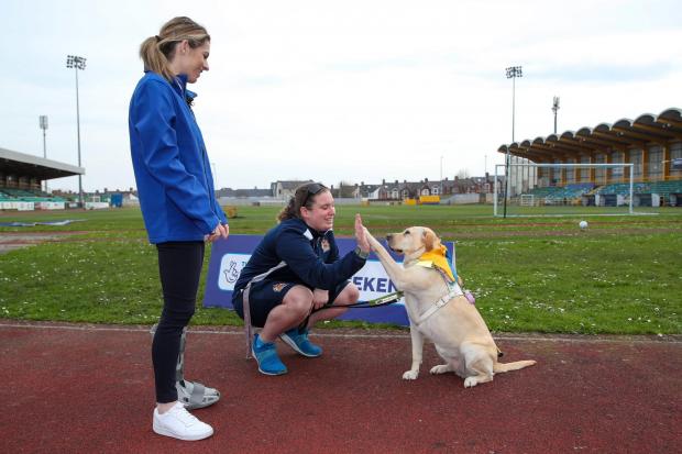 Karen Carney with Barry Town United's pan-disability coach Chloe McBratney and her guide dog Emily at the launch of a new ticket scheme.