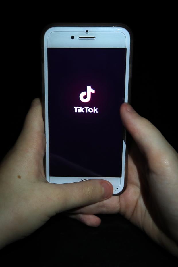 Barry And District News: A person with TikTok open on their phone. Credit: PA