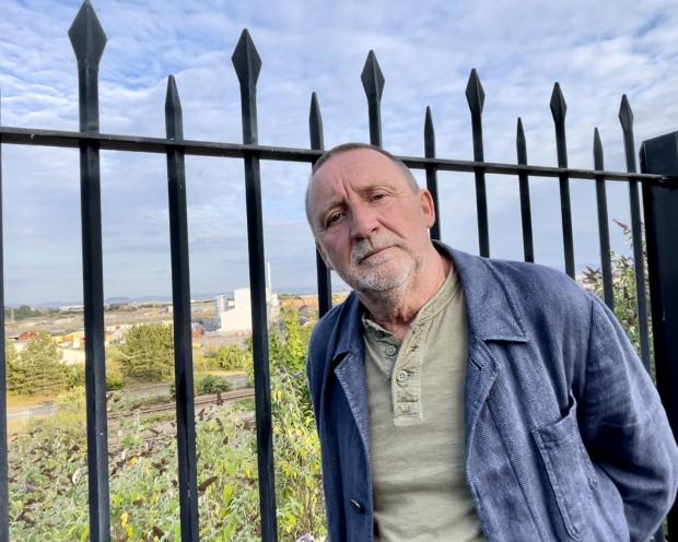 Barry And District News: Paul Robertson, Chair of the Docks Incinerator Action Group, stands on Dock View Road overlooking the Aviva incinerator. Photo: Siriol Griffiths