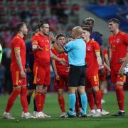 FRUSTRATION: Wales’ Gareth Bale argues with the referee after he awarded a penalty and sent off Neco Williams