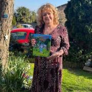 Sue Davies with her children's book The Riddle of Roary