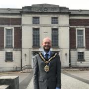 Mayor of Barry, Cllr Ian Johnson, outside Barry Memorial Hall where the weightlifting competition was held at the 1958 Empire Games.