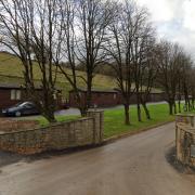 A farm is facing legal action for building a business  community in its stables without planning permission