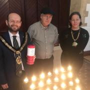Candle lighting event with the mayor (left)