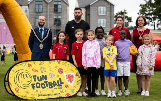Barry Town Mayor Cllr Ian Johnson(L) and consort Cllr Millie Collins (R) with  former Wales football internationals Helen Ward (R), Joe Ledley (C) and Fun Football participants.