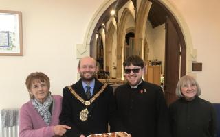Cllr Ian Johnson, mayor of Barry, with Father Dan Barnes-Davies (centre), before giving out hot cross buns to parishioners at St Mary’s Church on Good Friday